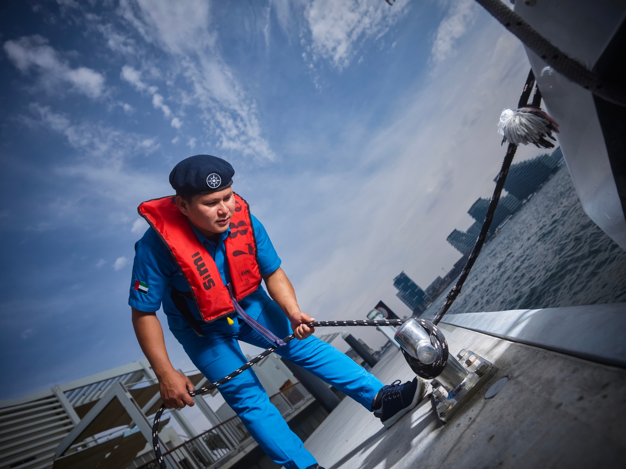 Maritime crew member securing a vessel alongside