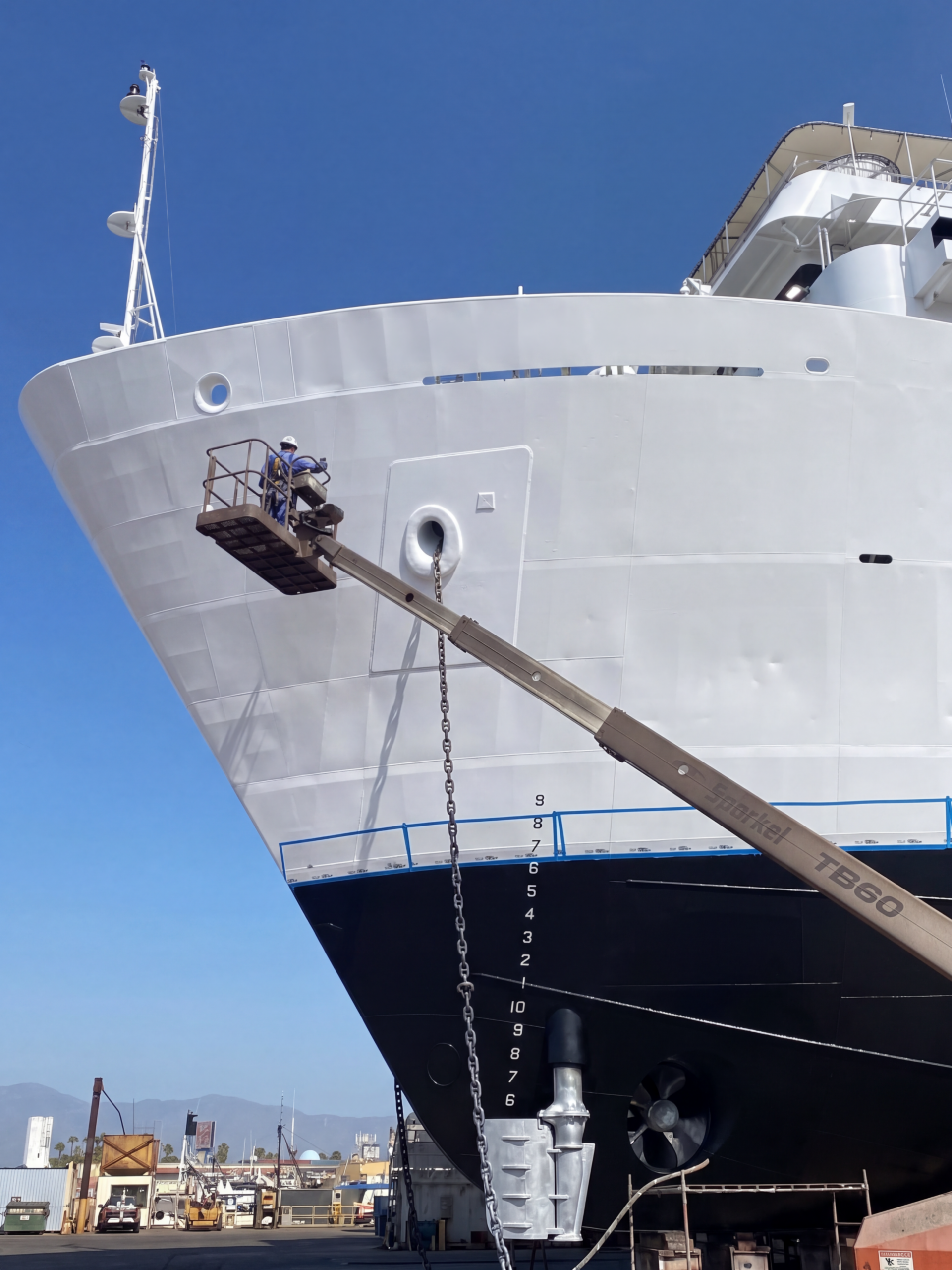 Technician working on the hull of a vessel in dry dock